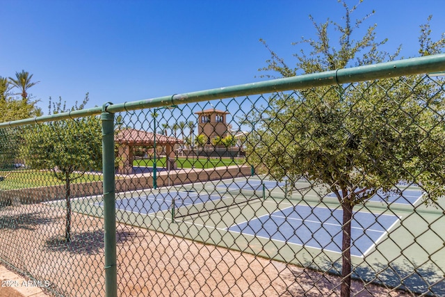 view of home's community with tennis court