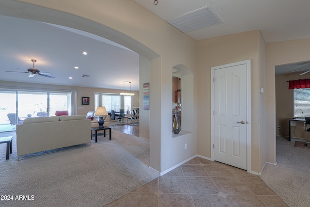 interior space featuring ceiling fan and light carpet