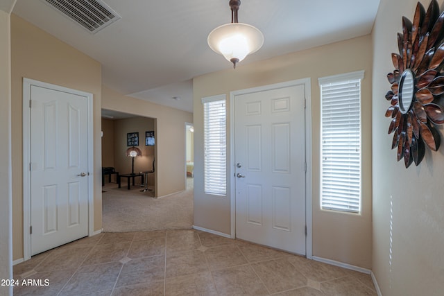 tiled entryway with a wealth of natural light