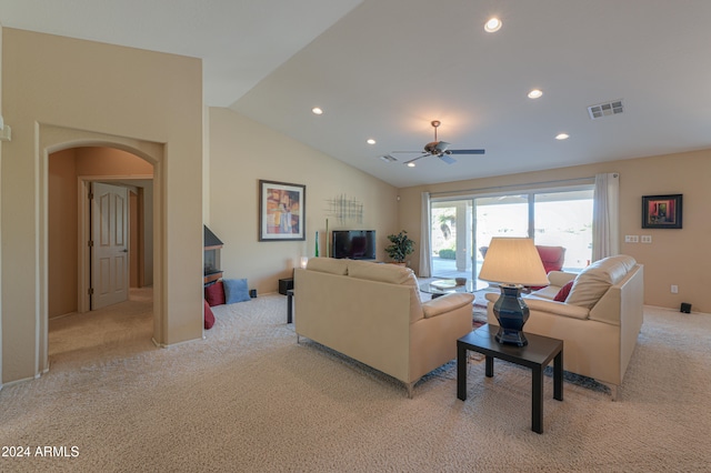 carpeted living room with ceiling fan and vaulted ceiling