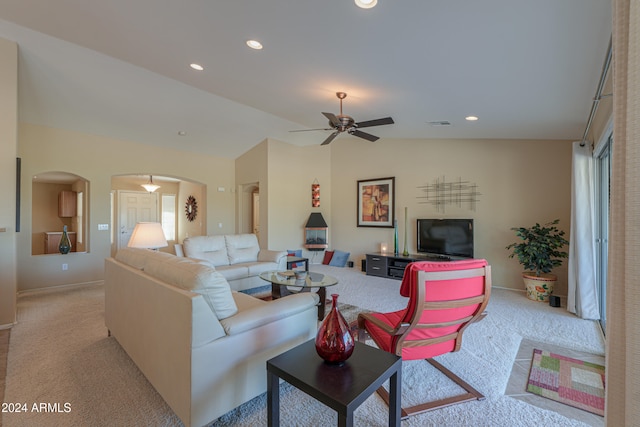 living room featuring ceiling fan, light colored carpet, and lofted ceiling