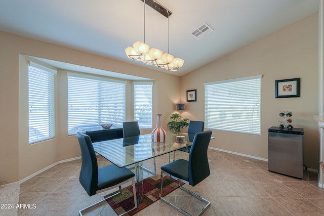 dining area featuring a notable chandelier, plenty of natural light, lofted ceiling, and light tile patterned floors