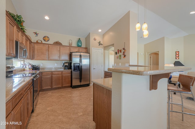 kitchen with stainless steel appliances, a kitchen breakfast bar, high vaulted ceiling, decorative light fixtures, and light tile patterned floors