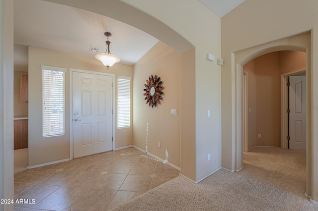 entrance foyer featuring light colored carpet