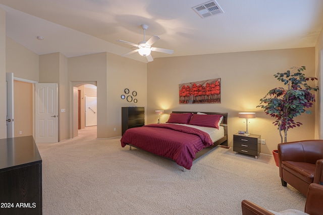 bedroom featuring ceiling fan, light colored carpet, and lofted ceiling