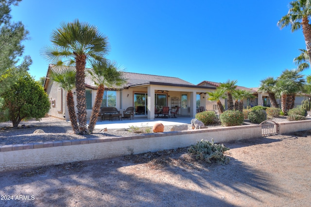 view of front of property with a patio and ceiling fan