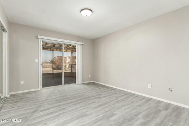 empty room with light hardwood / wood-style flooring