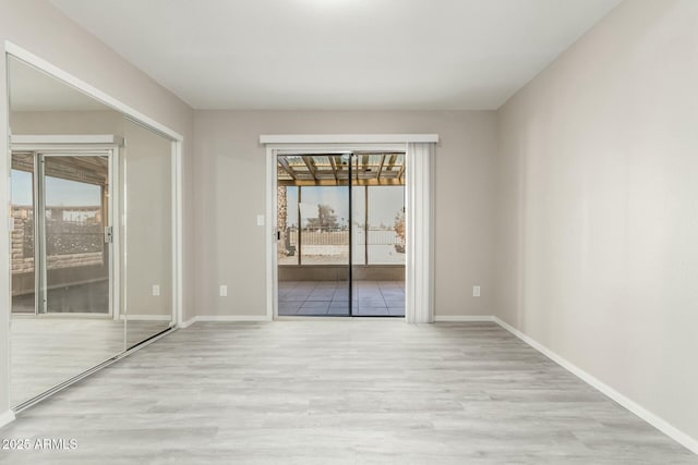 spare room featuring light wood-type flooring