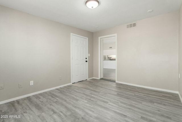 empty room with light hardwood / wood-style floors