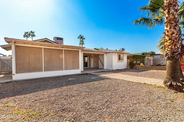 back of house featuring a sunroom