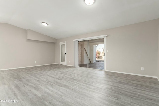 unfurnished room with vaulted ceiling and hardwood / wood-style floors