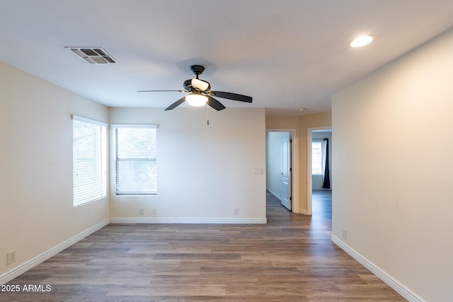 231 N Nash Way, Chandler, AZ 85225 - empty room with a ceiling fan, a healthy amount of sunlight, visible vents, and wood finished floors