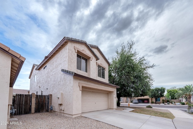 231 N Nash Way, Chandler, AZ 85225 - view of side of property with concrete driveway, stucco siding, fence, and a garage