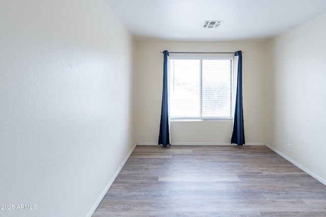 231 N Nash Way, Chandler, AZ 85225 - unfurnished room with baseboards, visible vents, and wood finished floors