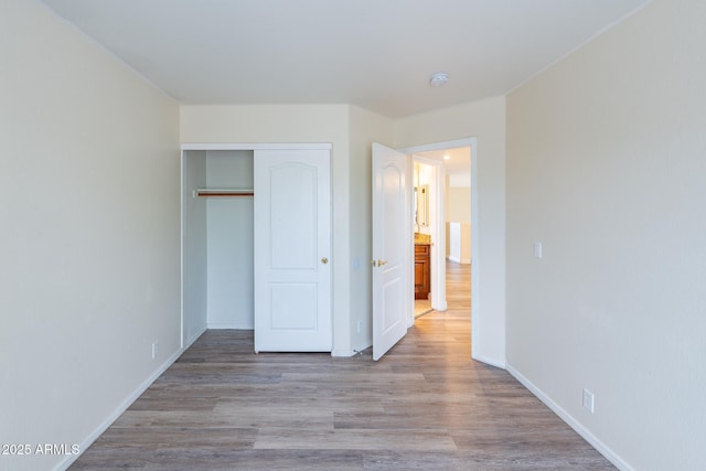 231 N Nash Way, Chandler, AZ 85225 - unfurnished bedroom with a closet, baseboards, and wood finished floors