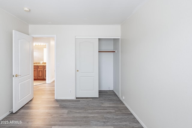 231 N Nash Way, Chandler, AZ 85225 - unfurnished bedroom with baseboards, a closet, and wood finished floors