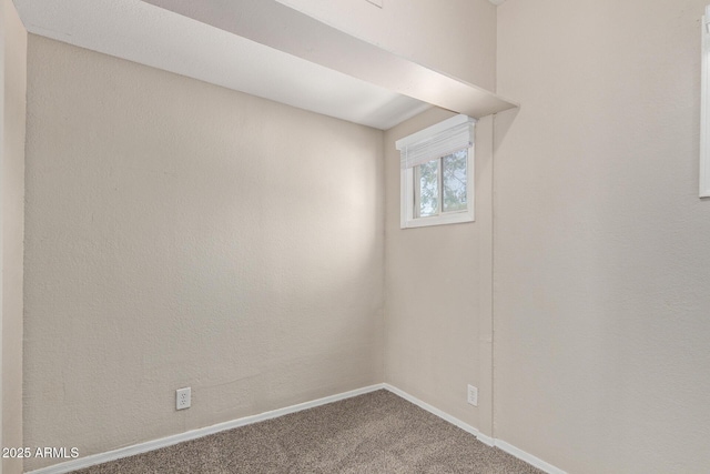 unfurnished room with carpet floors and baseboards