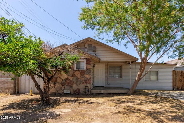 view of front of house featuring fence and stone siding