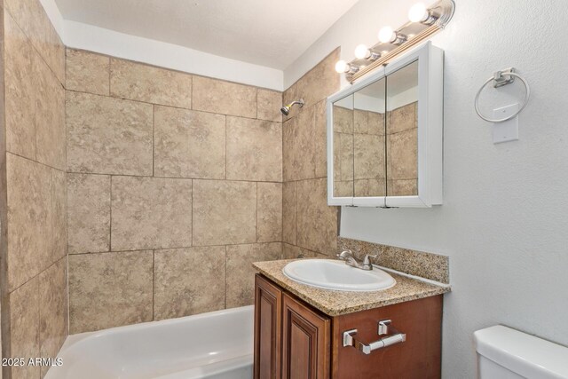 full bathroom featuring vanity, bathtub / shower combination, and toilet