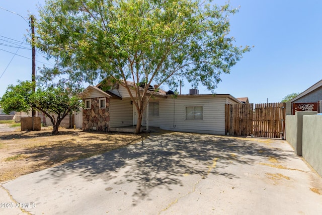 ranch-style home featuring a gate, fence, and driveway