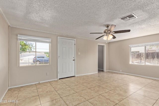 spare room with visible vents, baseboards, ceiling fan, a textured ceiling, and light tile patterned floors