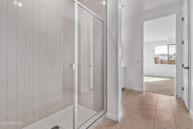 bathroom featuring walk in shower and tile patterned flooring