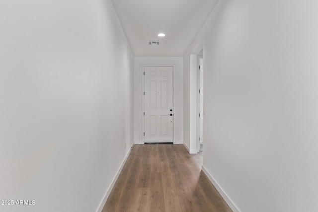 hallway with hardwood / wood-style flooring