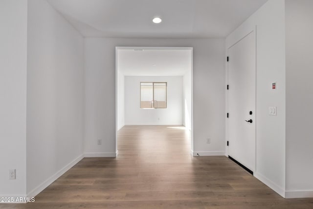 hallway with dark hardwood / wood-style flooring