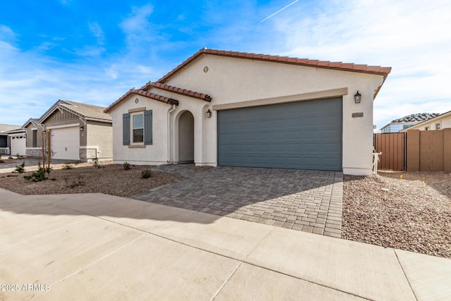 mediterranean / spanish-style house with a garage