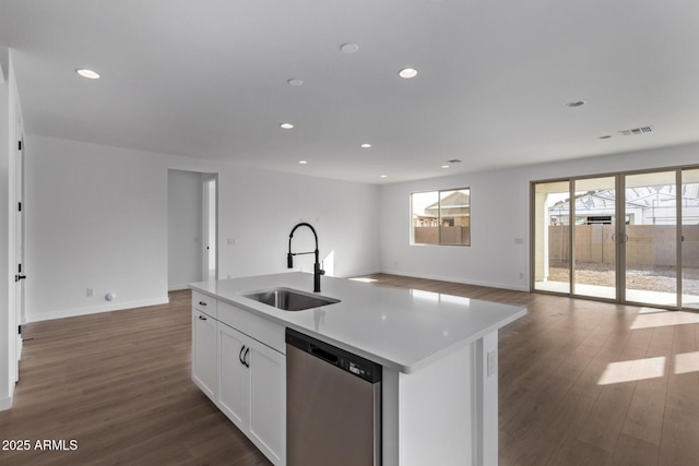 kitchen featuring sink, white cabinets, dark hardwood / wood-style flooring, stainless steel dishwasher, and a center island with sink