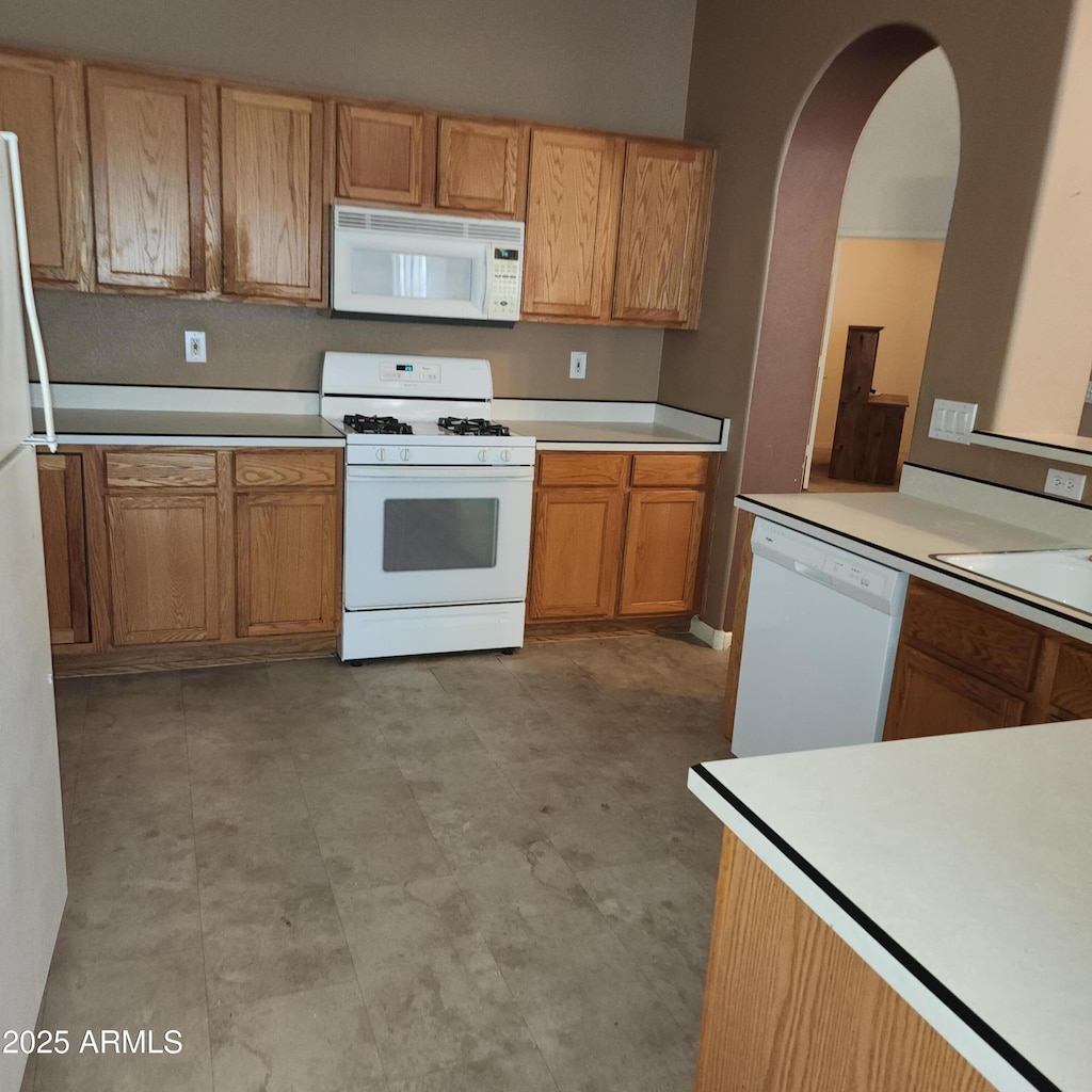 kitchen with sink and white appliances