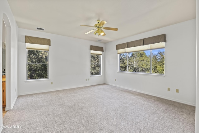 spare room featuring ceiling fan and light carpet