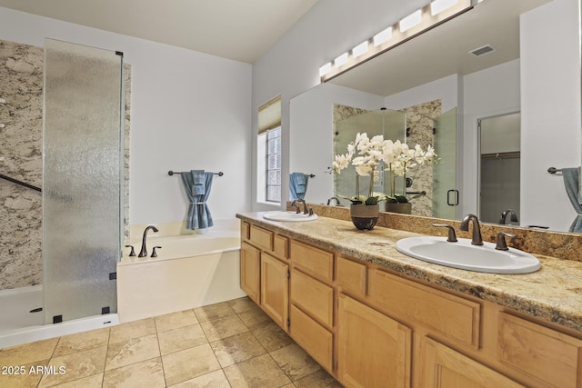 bathroom featuring shower with separate bathtub, vanity, and tile patterned floors