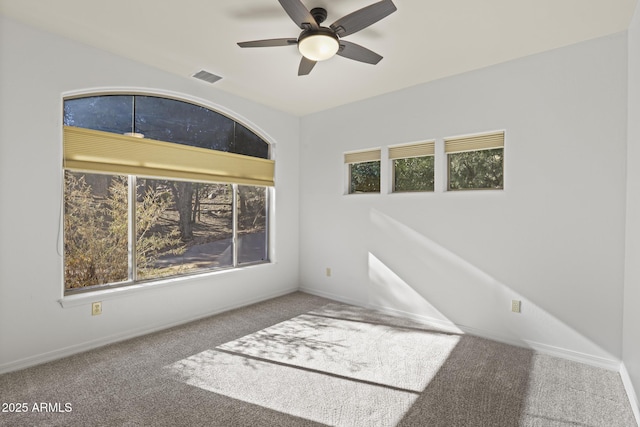 carpeted empty room featuring ceiling fan