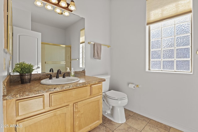 bathroom with tile patterned flooring, vanity, an enclosed shower, and toilet