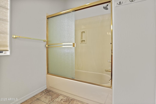 bathroom featuring tile patterned flooring and combined bath / shower with glass door