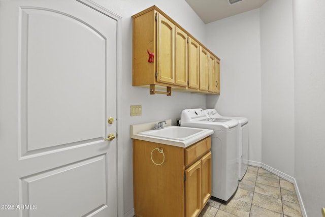 laundry area with separate washer and dryer, sink, light tile patterned flooring, and cabinets