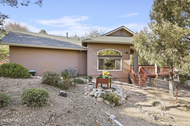 rear view of property with a deck and central air condition unit