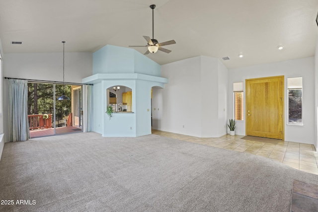 unfurnished living room with light colored carpet, high vaulted ceiling, and ceiling fan