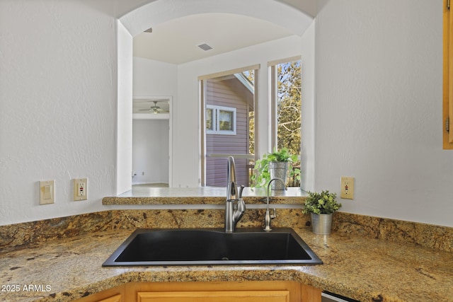 kitchen with ceiling fan and sink