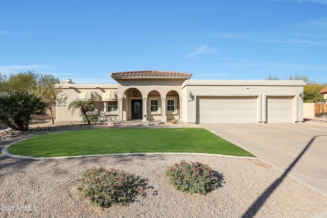 view of front of house featuring a garage and a front yard