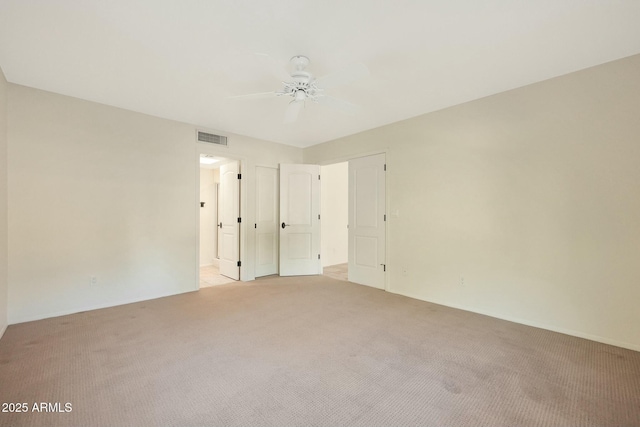 unfurnished bedroom featuring light colored carpet and ceiling fan