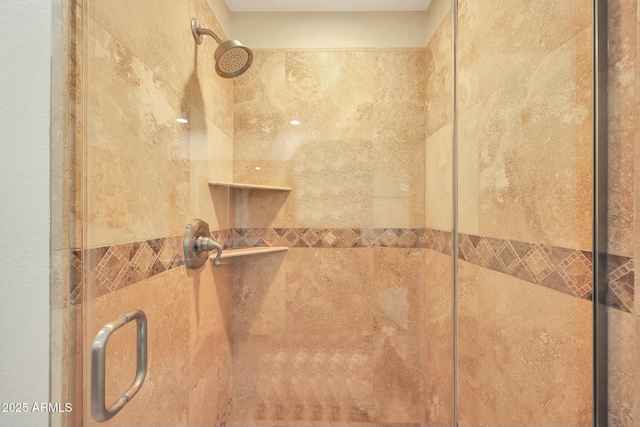 interior details with a shower with door