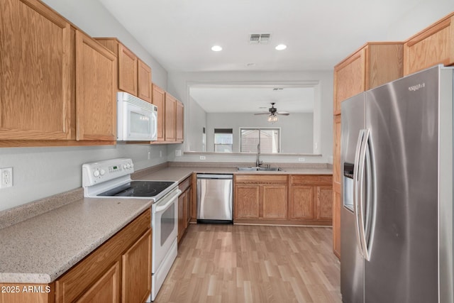 kitchen with visible vents, recessed lighting, appliances with stainless steel finishes, light wood-style floors, and a sink