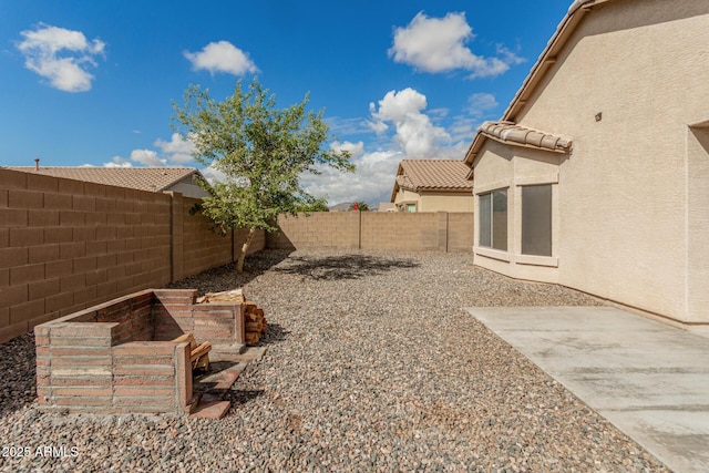 view of yard featuring a patio area and a fenced backyard