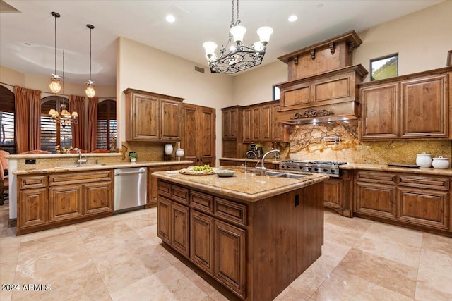 kitchen featuring sink, hanging light fixtures, a notable chandelier, stainless steel appliances, and a kitchen island with sink