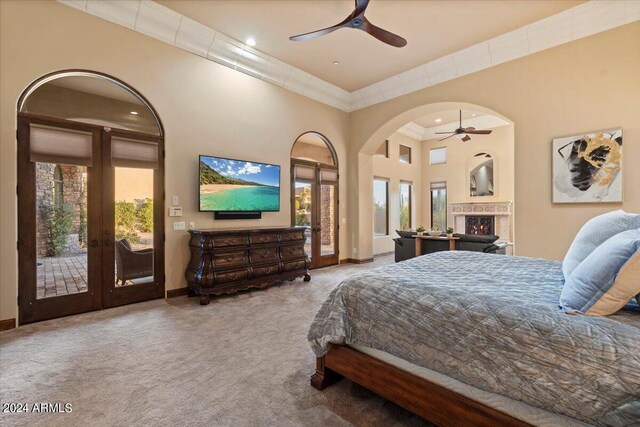 bedroom with french doors, a towering ceiling, carpet floors, and access to outside