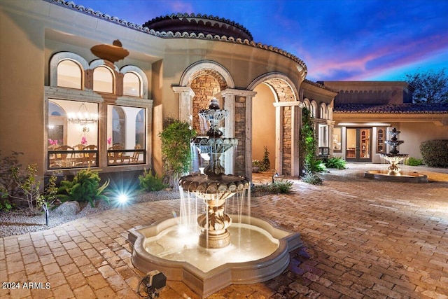 view of patio terrace at dusk