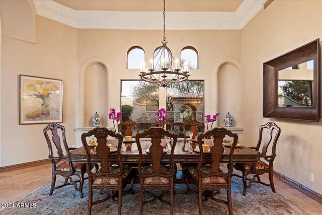 dining area with an inviting chandelier and ornamental molding