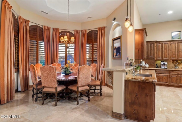 dining area with sink and a chandelier